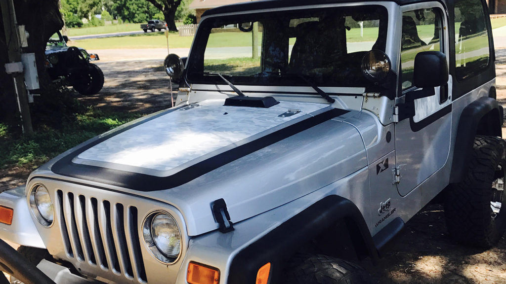 Custom racing stripes and camo wrap installation