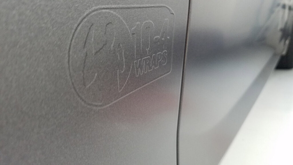 Textured logo on dark gray surface