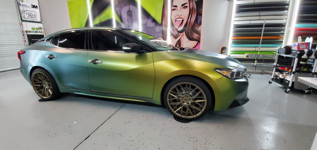 Nissan Maxima with custom vinyl car wrap in matte black finish.