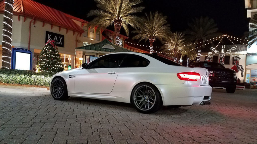 Satin White Pearl BMW M3 side profile in sunlight