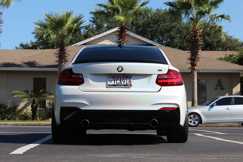 BMW M235 fully wrapped in satin white psychedelic vinyl with gloss black details.