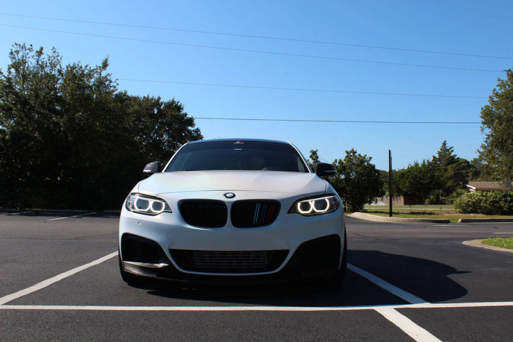 Carbon fiber spoiler and rear diffuser on a wrapped BMW M235 in Panama City, FL.