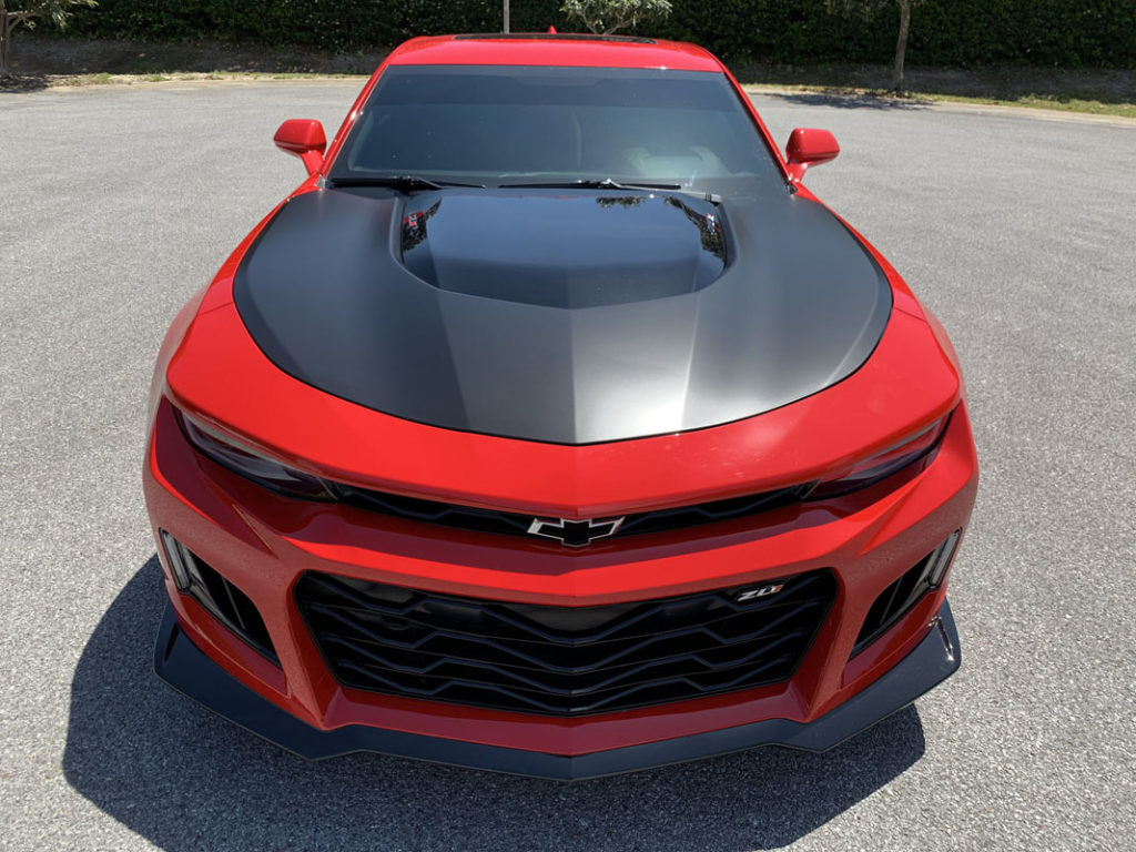 Rear end of Corvette C7 matte black wrap with red detail